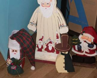 Wood Santas, door stoppers, the front left one is an actual brick. So cute!