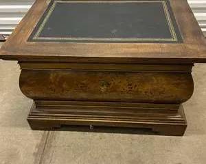 Elegant vintage burl wood coffee table chest featuring a black leather inlay top with gold tooling