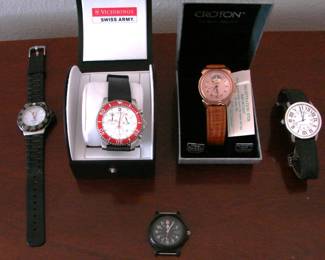 Men's Watches.  Top left to right:  Tag Heuer Formula One Watch in black, Victorinox Swiss Army Watch, Croton Automatic Watch in gold, and Cartier Ronde Solo Stainless Steel Watch.  At the bottom a black Swiss Army Watch without band.