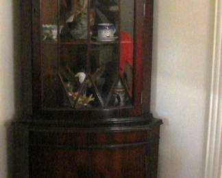 Pair of corner cabinets.  5-feet tall.  Curved veneer front at botton and window panes at top.