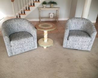Upholstered swivel chairs; accent table