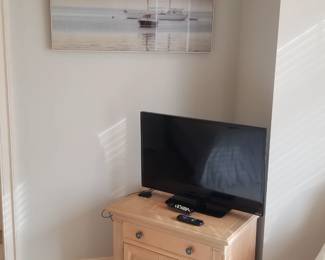 One-drawer cupboard; TV. Nautical art