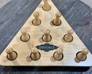 Classic Brunswick Billiards accessory featuring a triangular wooden rack with ten pegged pins.