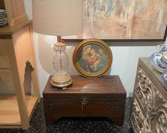 Antique glass side table, artwork, carved wood trunk 