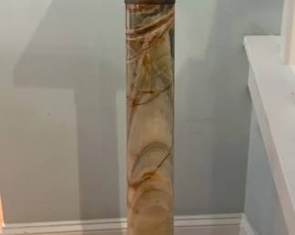 A striking early 1900s Neoclassical pedestal crafted from richly banded onyx in shades of cream, amber, and celadon green. The column features finely detailed metalwork with floral motifs and a smooth swivel top, adding both artistry and function. Likely Italian or French in origin, this sophisticated piece embodies timeless European elegance and serves beautifully as a display stand for fine art, sculpture, or floral arrangements. Measures approximately 35.5" H with a 10" x 10" top and 9" x 9" base.