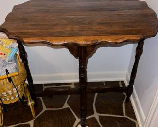 wooden side table with a scalloped top