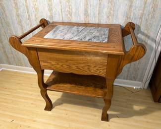 vintage oak side table with a marble insert top and towel bars