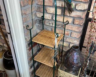 wrought iron plant stand with wicker shelves