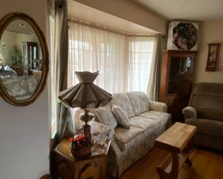 Corner curio cabinet, sofa with matching love seat, vintage mirror and lamps