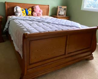 Queen size sleigh bed with matching nightstands, dresser with mirror and highboy dresser