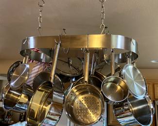 Hanging ceiling mounted pot rack with assorted cooking pots and lids sold as set