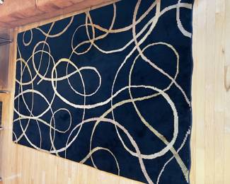 Black area rug with swirls, 61" x 96"