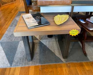 Outdoors table made out of metal and water resistant wicker. $30 + tax