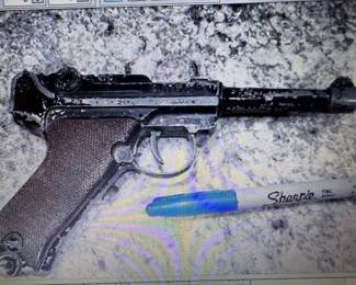 Toy Luger cap gun. https://modestlambestatesales.hibid.com/