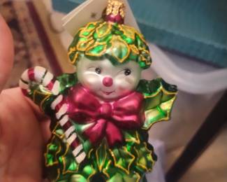 This is a Christopher Radko "Holly Jean" ornament is currently valued in the collector's market between approximately $155 and $225. This ornament has a broken hand. Listed at 100 dollars. These ornaments are hand blown glass.