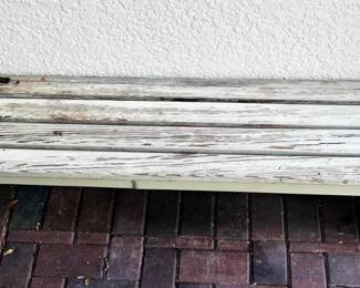 rustic farmhouse-style wooden bench with a distressed white finish