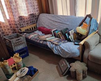 Nice Clean Futon Couch. Hanging light fixture and books on coins