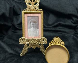 Brass frame stand, 7"H, $9,  Vtg woman pic, pink border,  3.5"H, $30.  Gold round vintage frame, 3"D, $7.