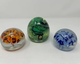 Orange, yellow, red glass paperweight,  $12.  Vintage Green Kerry Irish glass paper weight,  $18.                       Bart Zimmerman blue glass paper weight,  $14