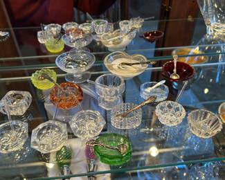Clear salt cellars w/ spoon, $4 each.  Red, yellow, orange, green salt cellars $6 each. Clear and clear with gold larger salt cellars, $7 each