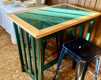 a breakfast or side table. Mission or Arts and Crafts-style pub table with green ceramic tile top and a wooden frame and legs, blue metal stools