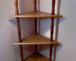 This is a five-shelf etagere wooden corner shelf with stick and ball detailing.