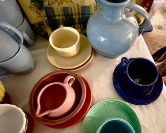 Fiesta pitchers, cups and saucers