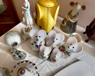 collection includes several small white mouse figurines with painted floral details.