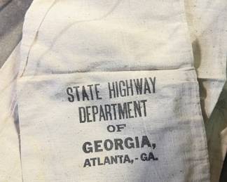 canvas bag with faded black text printed on it. The text identifies the bag's origin and purpose.
State Highway Department OF GEORGIA
ATLANTA, GEORGIA
