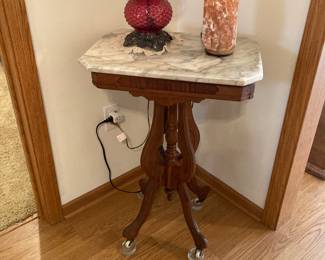 Antique small marble top accent table with Himalayan salt lamp and Fenton cranberry hobnail dresser lamp