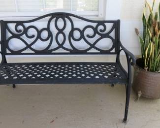 Black Cast Metal Patio Bench, Snake Plant in Copper Brass Footed Planter
