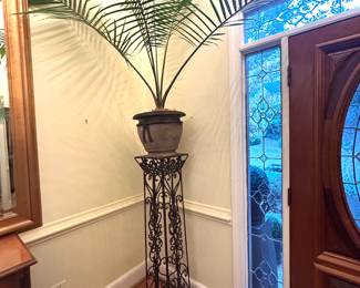 Large metal pedestals with large plants 
