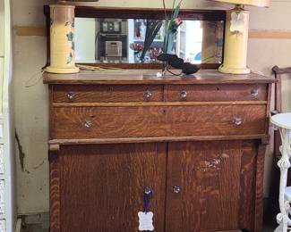 Wooden buffet. Wooden bookshelf. Vintage lamps. 