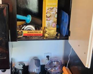Vintage cookie press, rolling pin, cookie cutters, Ninja food processor, can opener, cups, egg beater, metal tea cup, REI flask. 