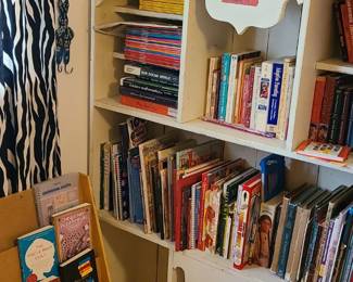 Children's books. Vintage white bookshelf. Leather tooled purses. 