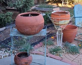 Outdoor pottery. Metal plant stands. 