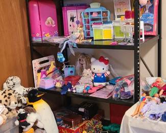 Vintage Barbie. Barbie play sets. A mountain of stuffed animals. Hello Kitty toys. Polly Pocket and other 90's/2000's kids toys. 