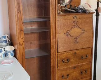 Victorian secretary/curio cabinet. Silver pitcher, cups, salt and pepper shakers. Metal lamp. 