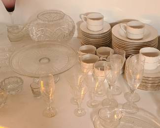 White tea set, many crystal and glass items such as cake stand, bowl, platter, glasses. Some with etched designs. 