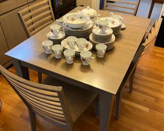 Canadel dining table with four chairs and “hidden” leaf.