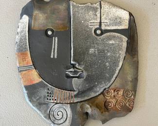 Raku-fired ceramic wall sculpture of an abstract face created by artist Doug DeLind.