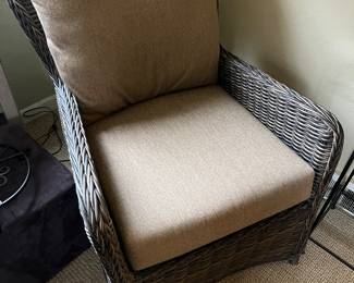 One of two matching wicker armchairs.