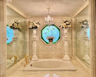 Carved marble pedestals and marble vases