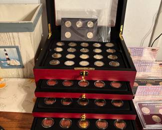 gold-plated 50 State Quarters coin collection housed in a cherrywood display case. The collection typically includes coins from both Philadelphia and Denver mints, covering the years 1999 to 2008