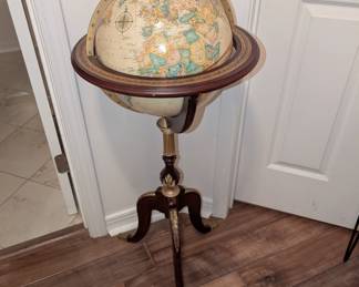 Antique style floor-standing terrestrial world globe on a wooden tripod base