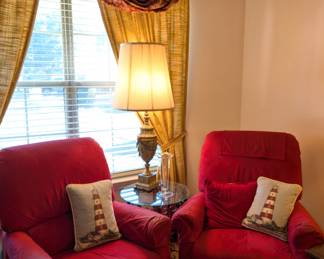Matching red armchairs, lighthouse throw-pillows