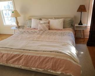 King bed with upholstered headboard; end tables; table lamps