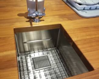 Island features a stainless steel bar sink