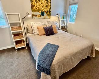 California King mattress set and two white ladder shelves