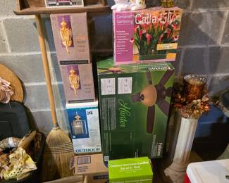 Brand new items, still in boxes, including a ceiling fan and light fixtures.